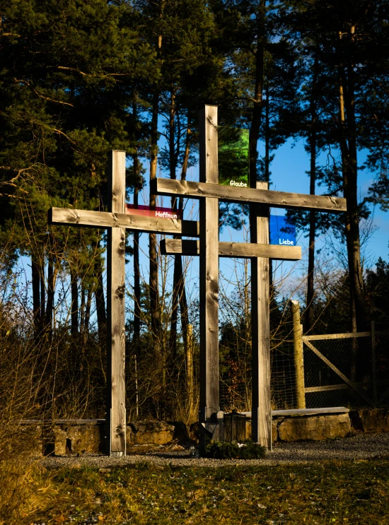 an artisticly shaped wooden cross with three crosses