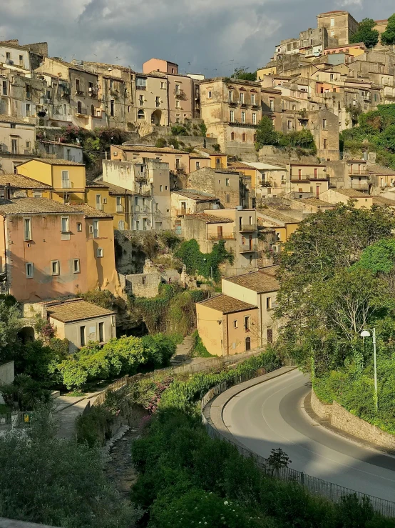 a hill village is shown with several old houses