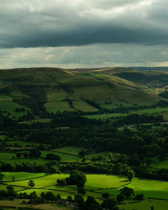 a mountain with green grass and rolling hills