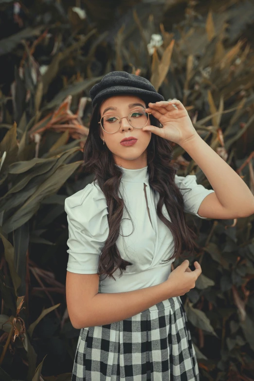 a woman that is standing in front of plants