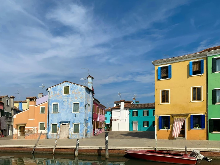 the boats are docked in the water beside buildings