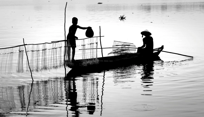 a black and white po of two people in a boat