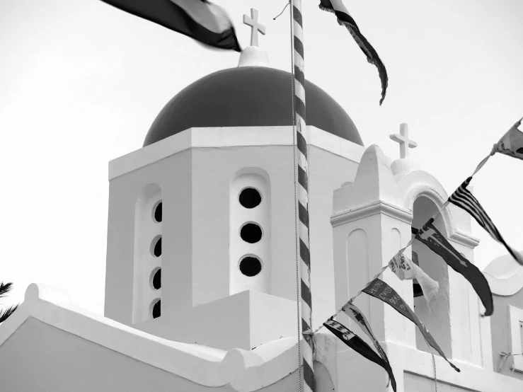 a church with flags flying next to it