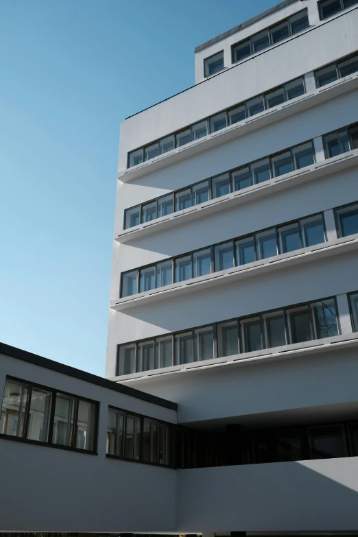 a high rise building with balconies and many windows