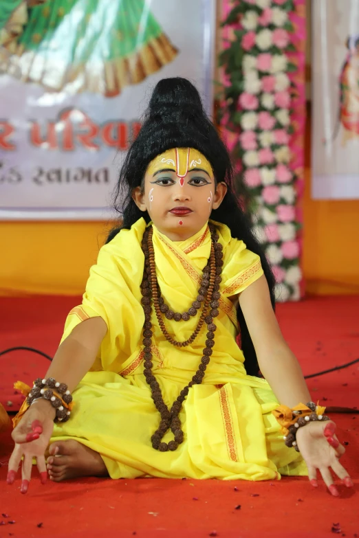 the woman is dressed in a yellow outfit and she has some jewelry on