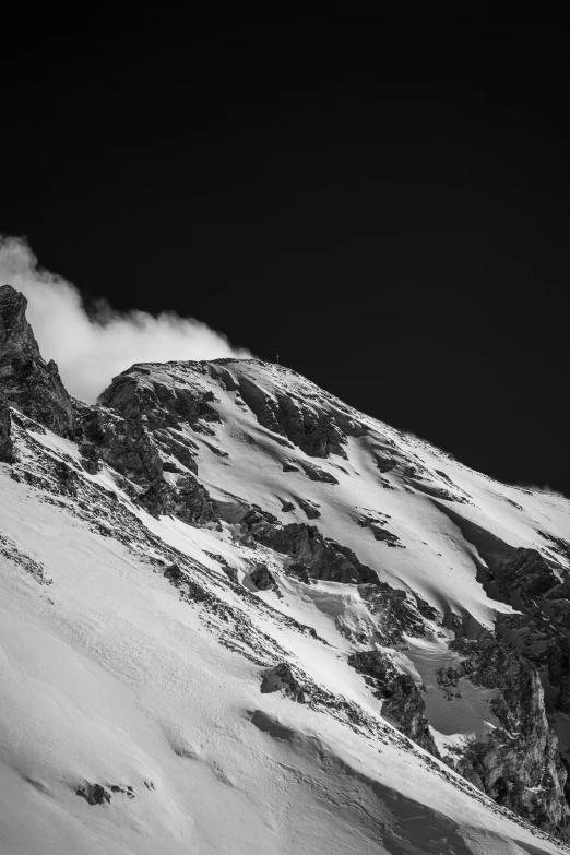 the sky is almost obscured by heavy snow, as it moves through a mountain