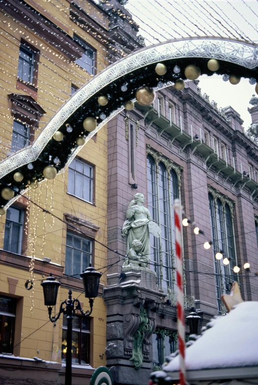 the arch is decorated with glass balls and snow