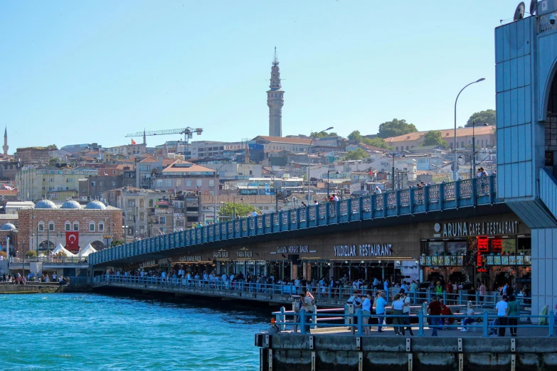 the people are going under this pedestrian bridge