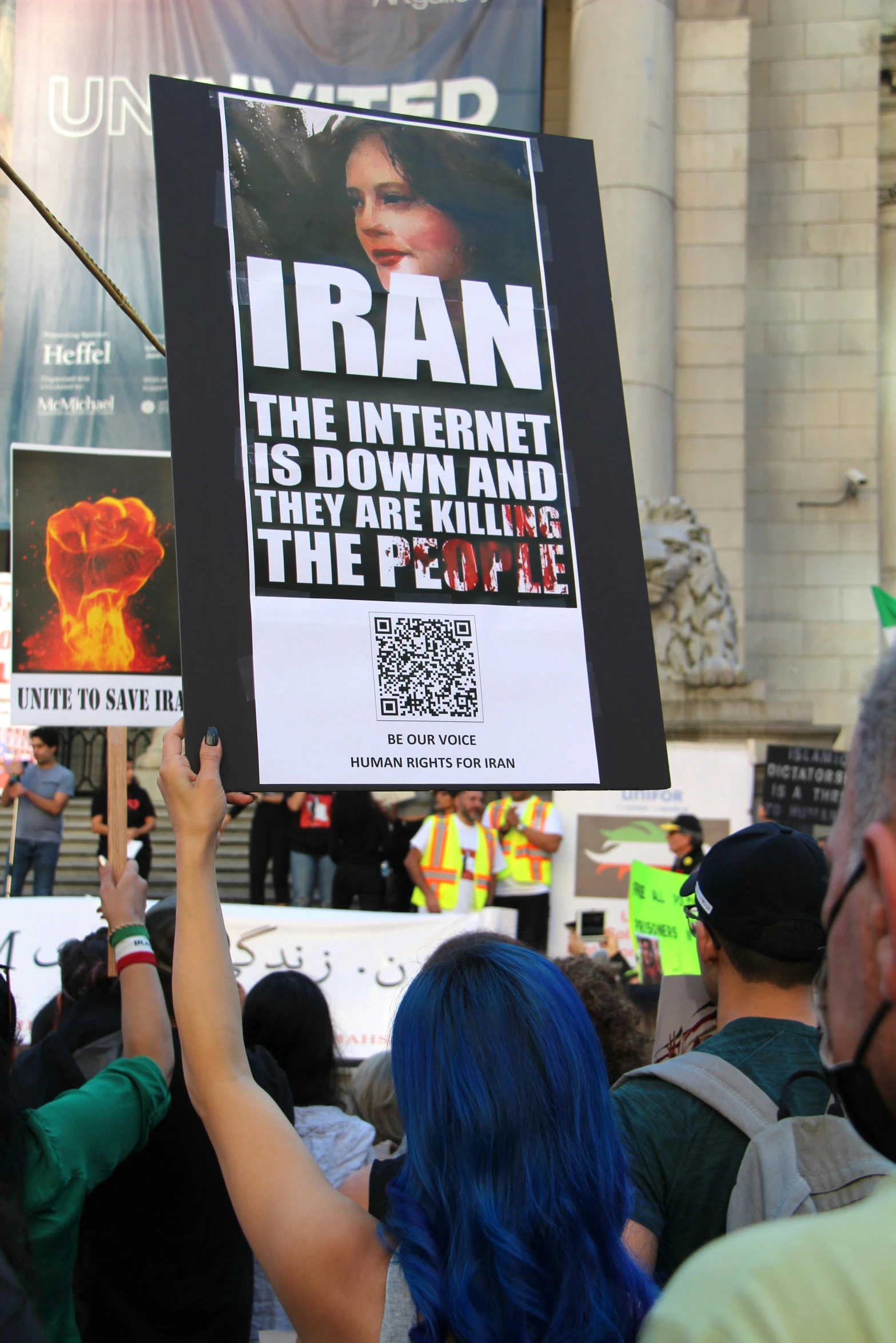 a protestors holds up a poster for the internet