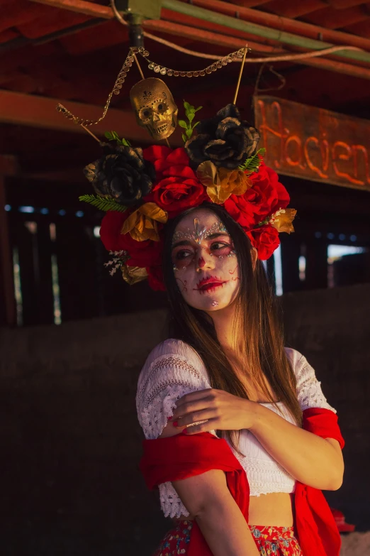 woman with flowers on her head standing in front of a sign