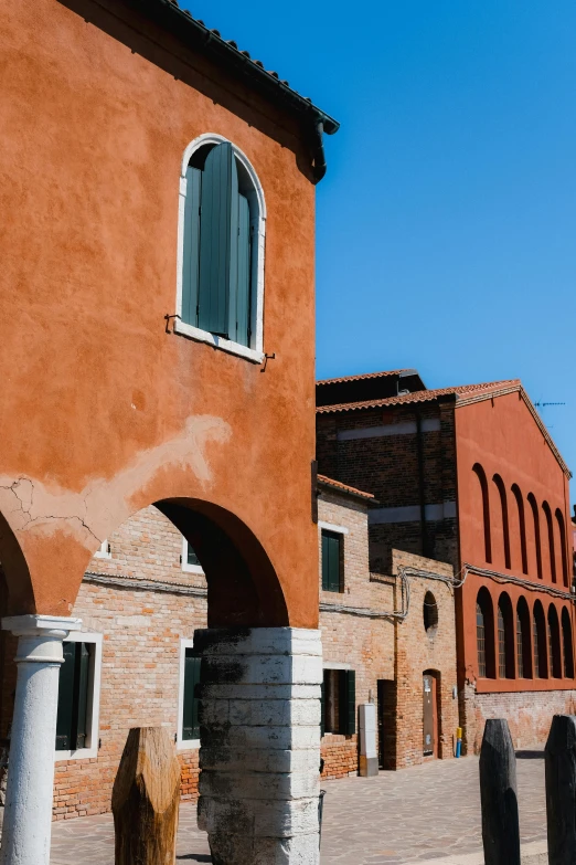 the red brick building has arches and arched windows