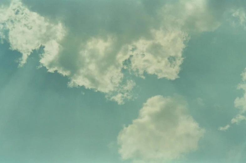 clouds and sun shining from underneath the plane