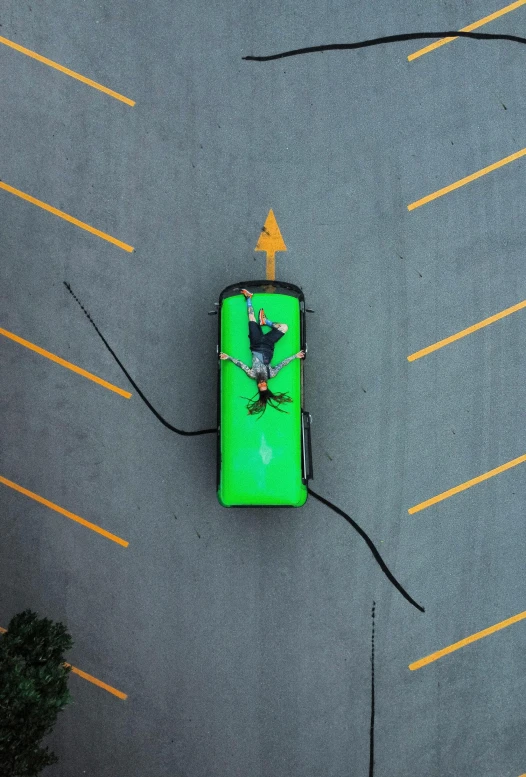 an overhead view of a green bench with a man standing on it