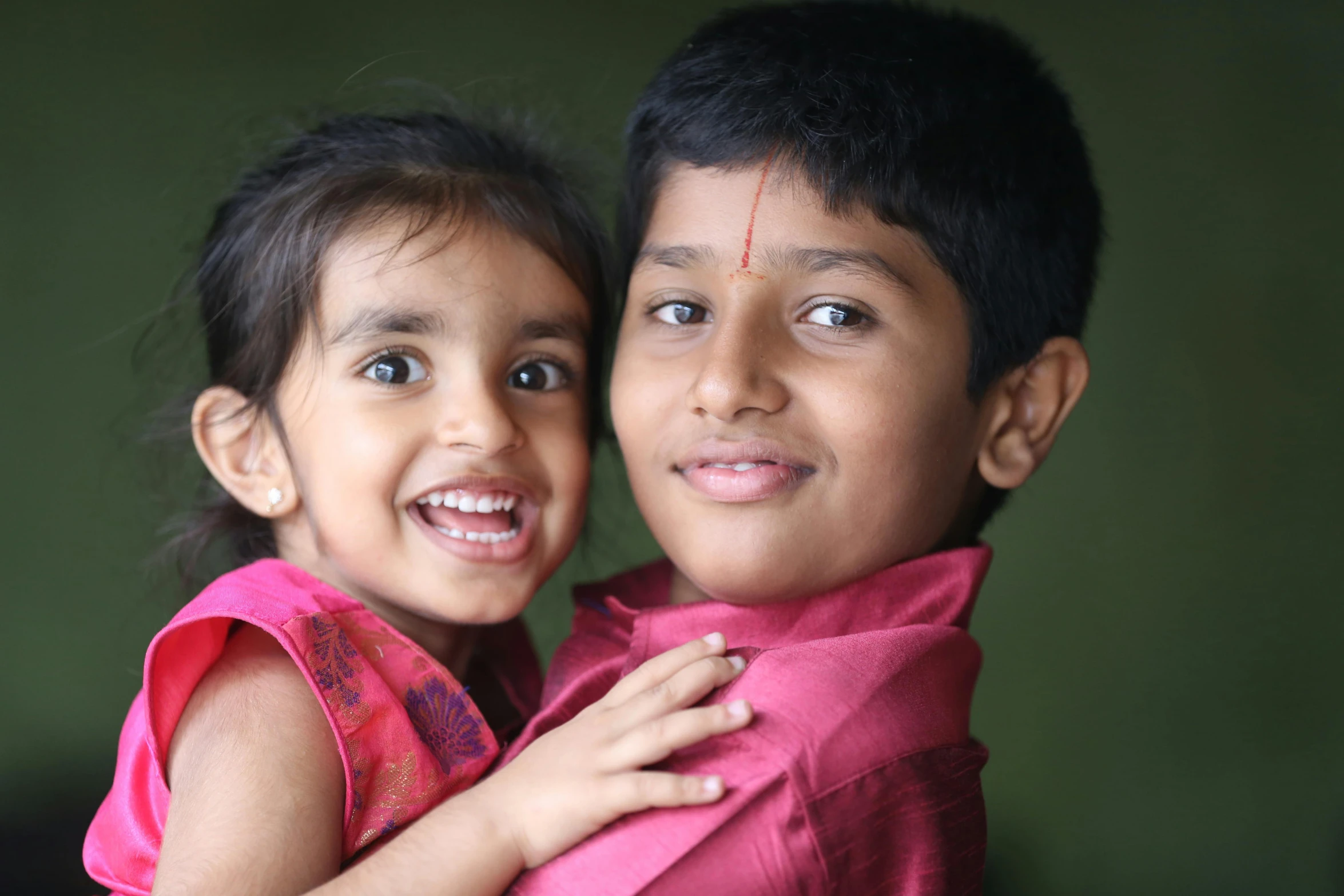 two young children posing for the camera