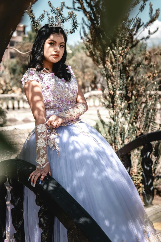 a beautiful woman in a blue dress posing for the camera