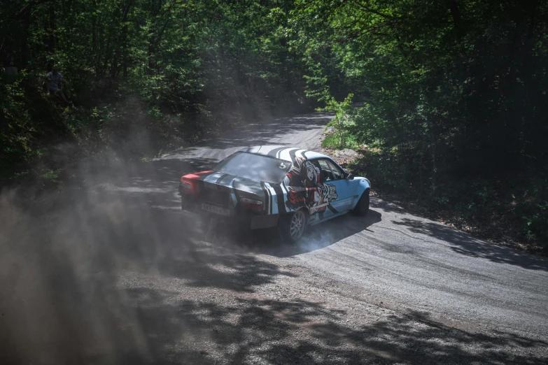 a dirt rally is racing as the car moves through the sand