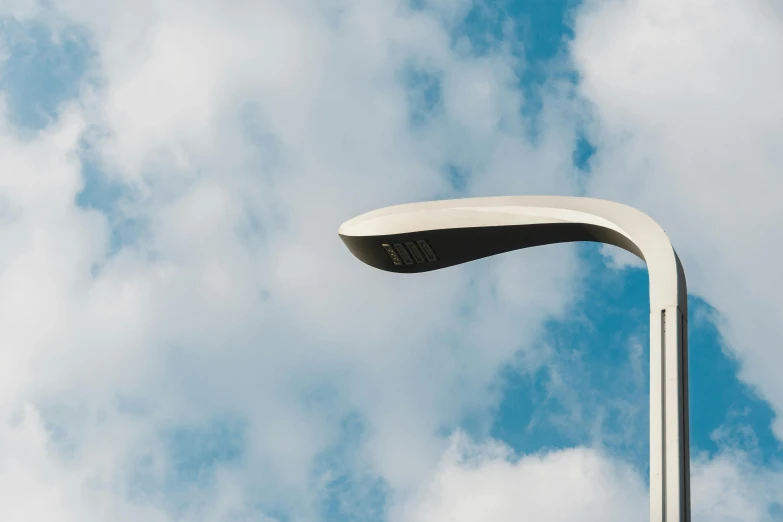 a street light on a pole under a blue sky