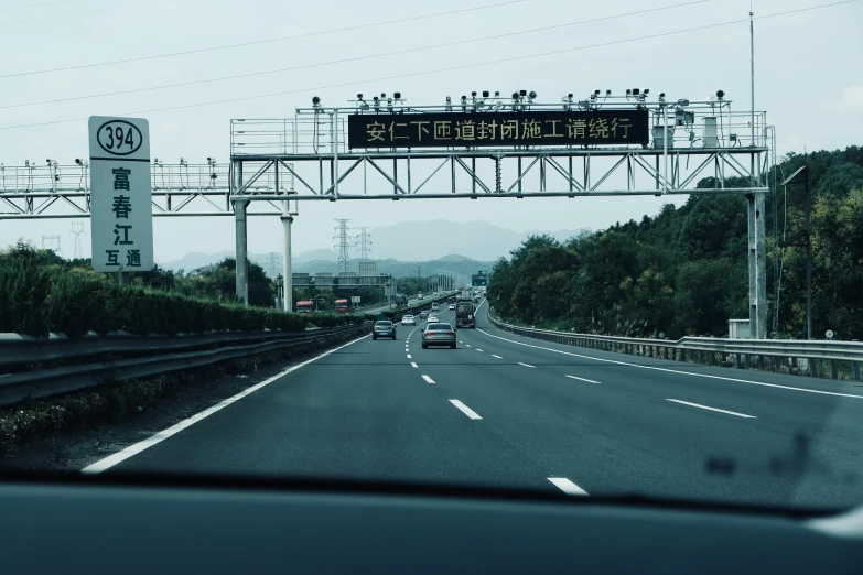 a very large open highway with several signs above