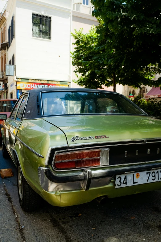 a green car parked in front of a street