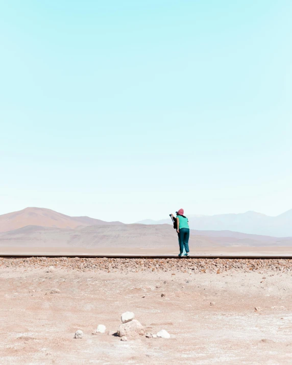 a man is flying a kite in a desert