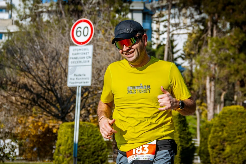 a person is running along the street by a speed limit sign