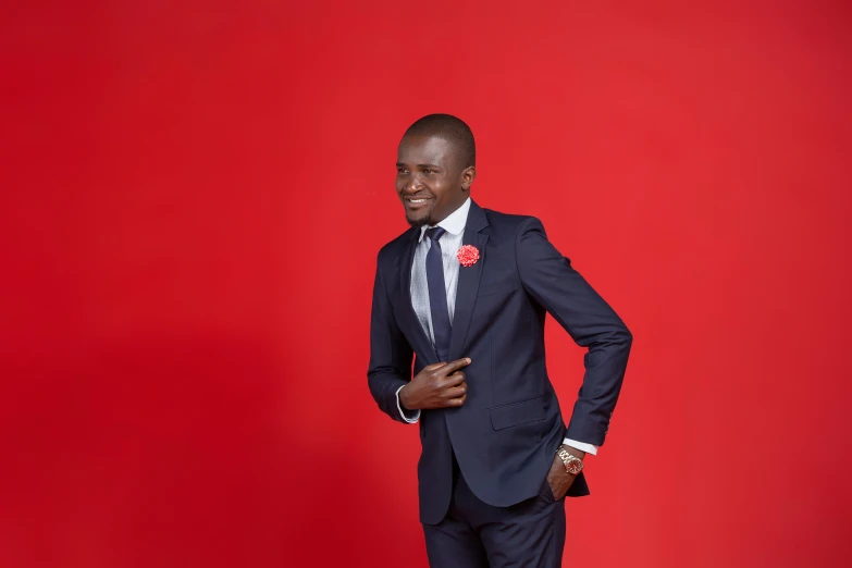 a smiling man in a blue suit standing