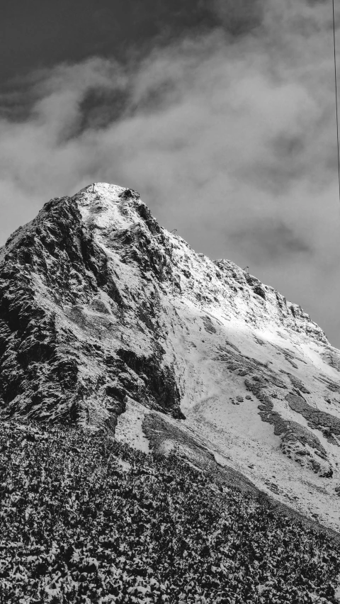 a view of a mountain is shown with an airplane in the air