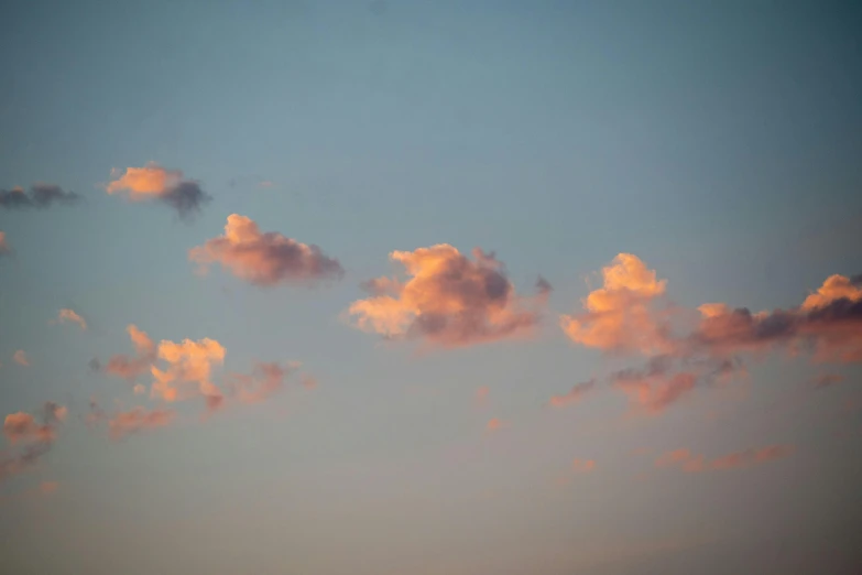 the sun is setting and clouds are pink