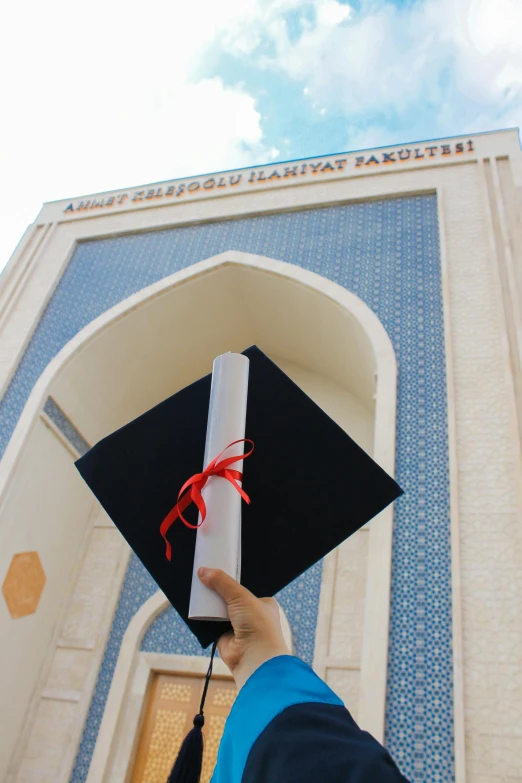 the graduate is holding the diploma at graduation