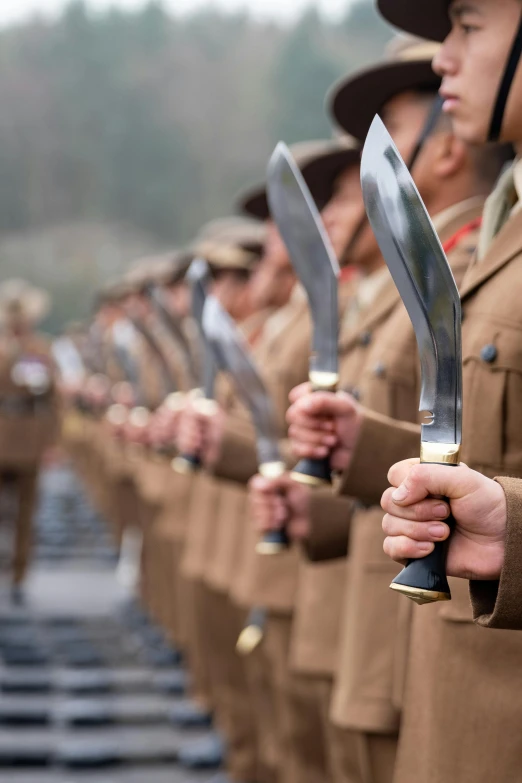 rows of uniformed soldiers holding large sword and dagger