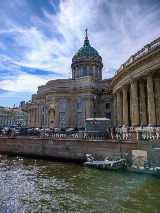 the river in front of the large building with the dome