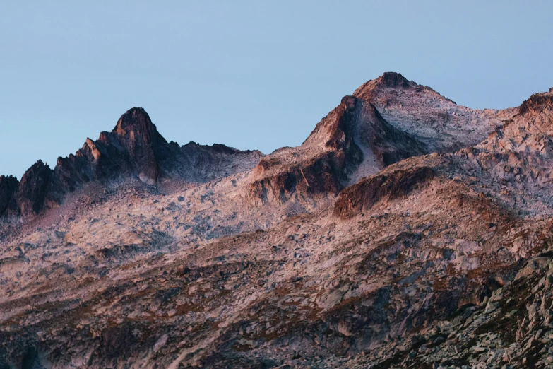 the sun setting on a mountain that has no snow