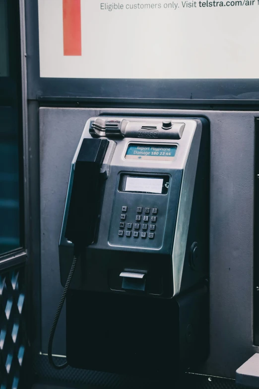 an old fashioned atm sitting on the side of a building