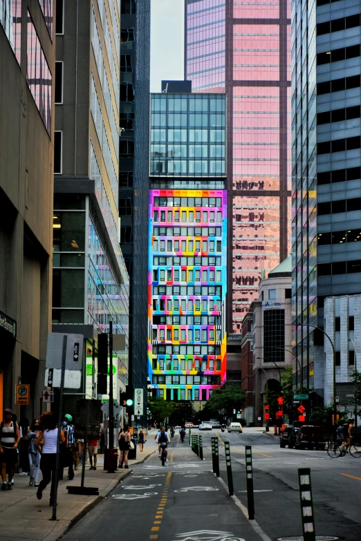 people walk around in an urban setting with tall buildings