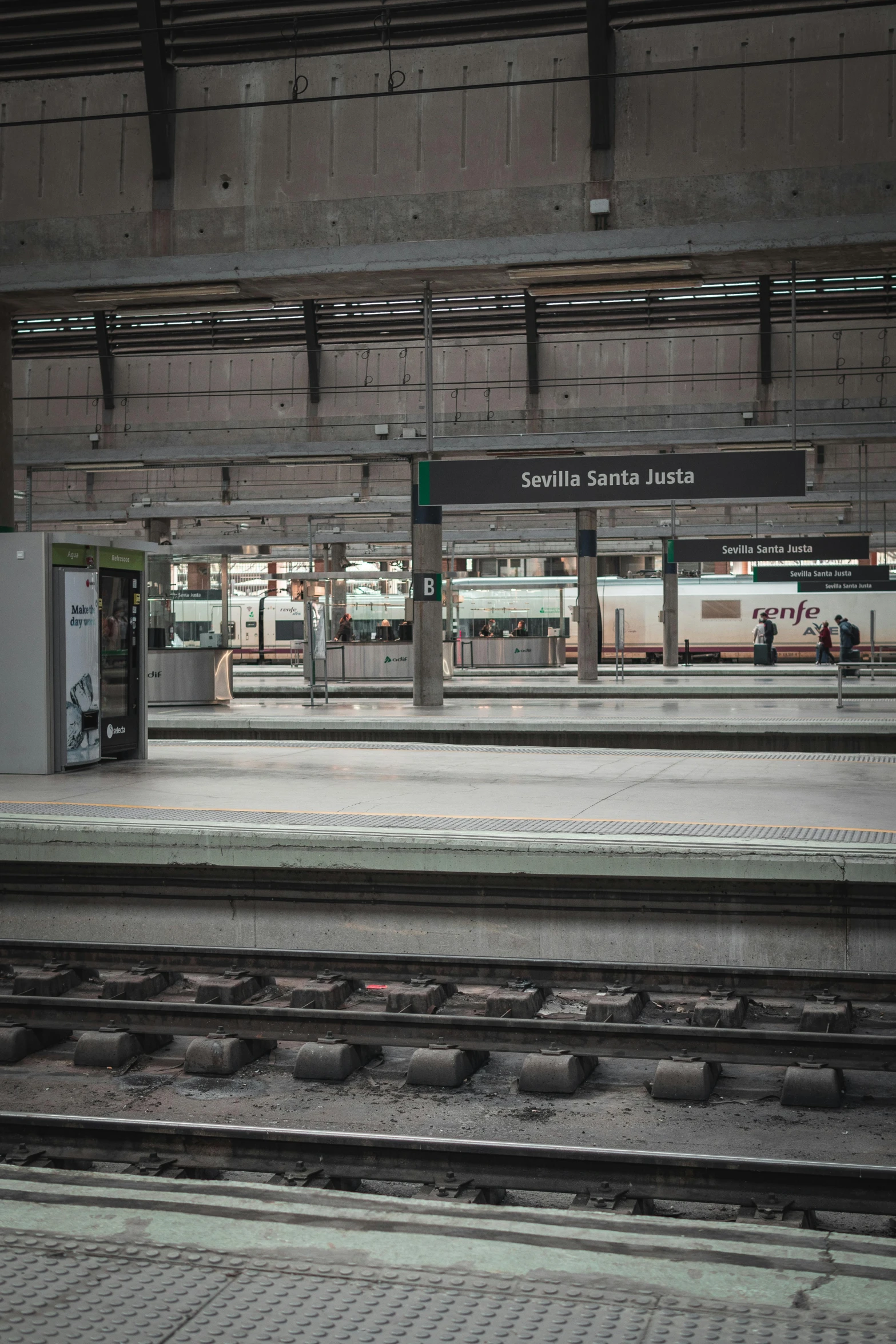 an empty train station filled with lots of tracks