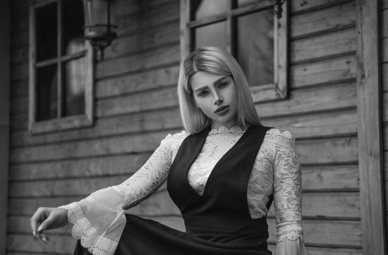 a woman in black dress sitting on a wooden floor