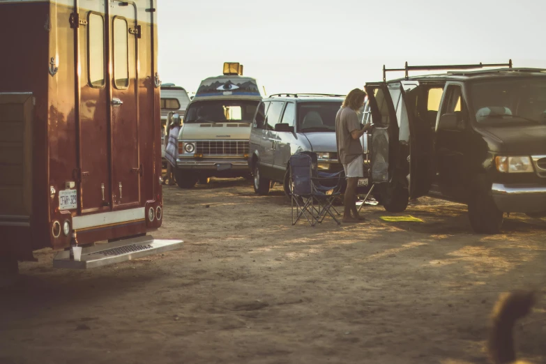 the vehicles are parked next to each other in the field