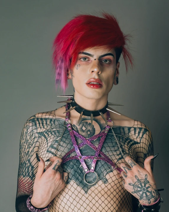 a woman wearing a harness with lots of tattoos