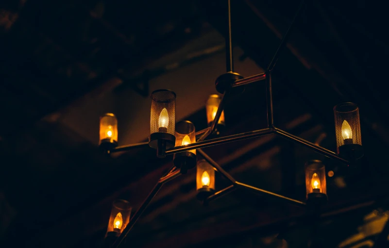 a large metal chandelier with glowing lanterns in it