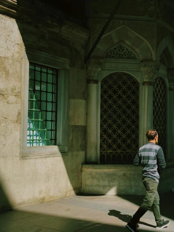 a man riding on a skateboard through a courtyard