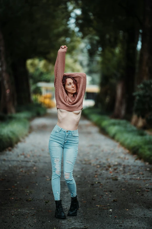 a young woman is holding her arms in the air