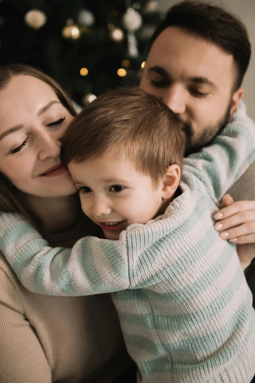 a man is holding his son while he poses for the camera