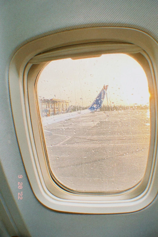 looking out the window at a plane in flight