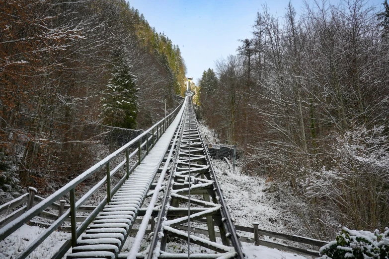 a wooden track in the snow that has snow on it