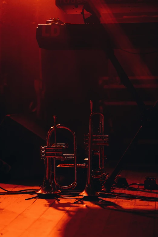 trumpetes and some music equipment in front of an empty piano