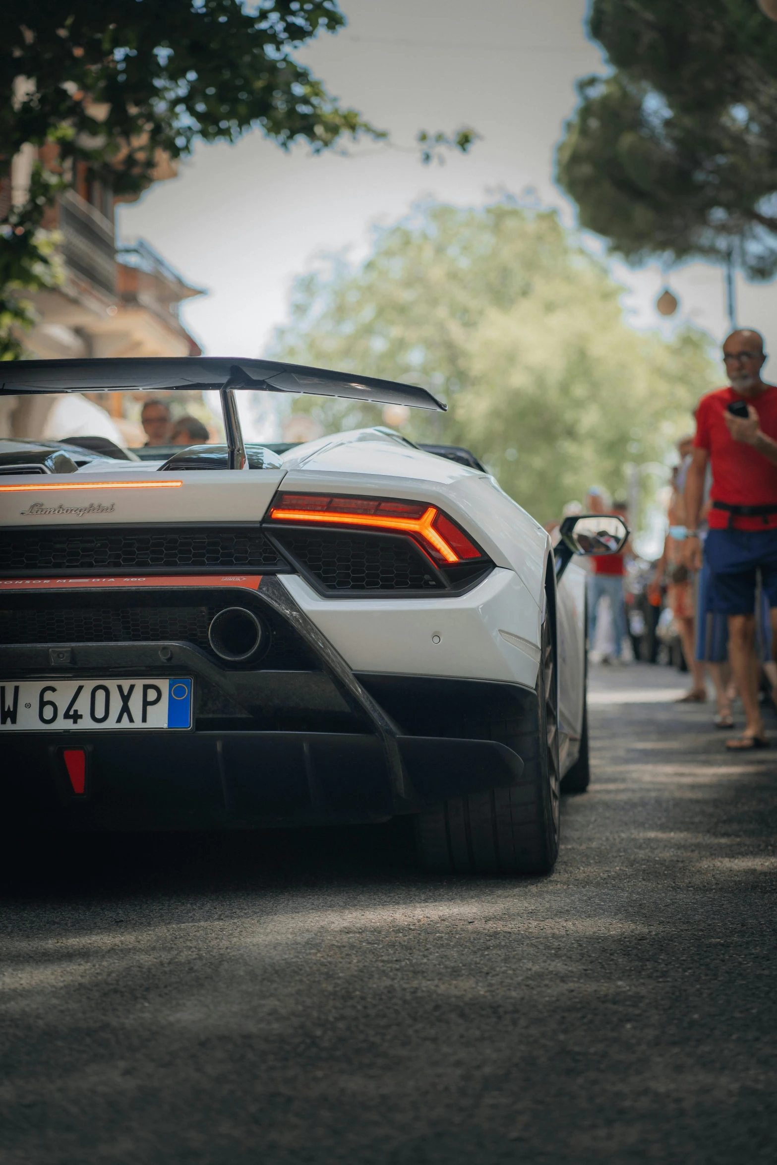 a sports car with the trunk of the top up parked on the street