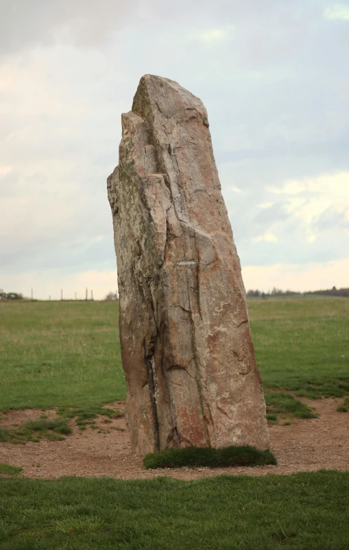 a large rock that is in the middle of a field