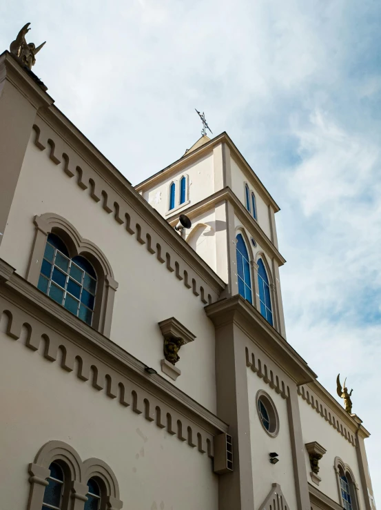 the white and blue architecture of a church with a clock on top