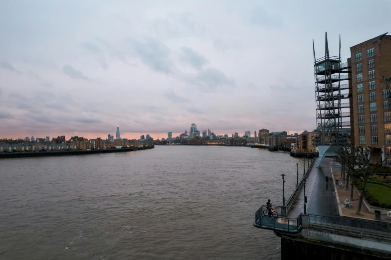 a body of water near a large city in the sunset