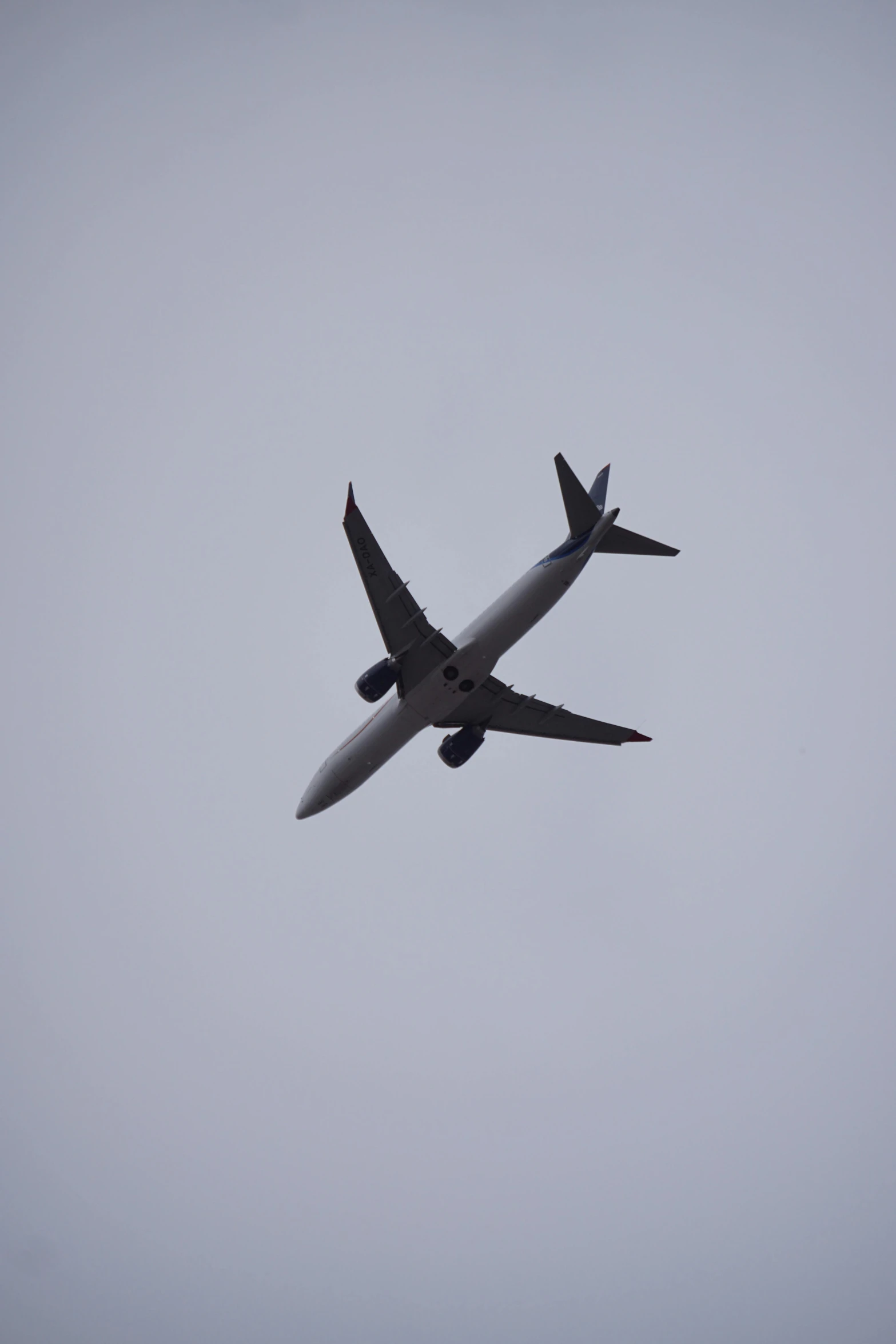 airplane is flying on the sky as it turns and touches the ground